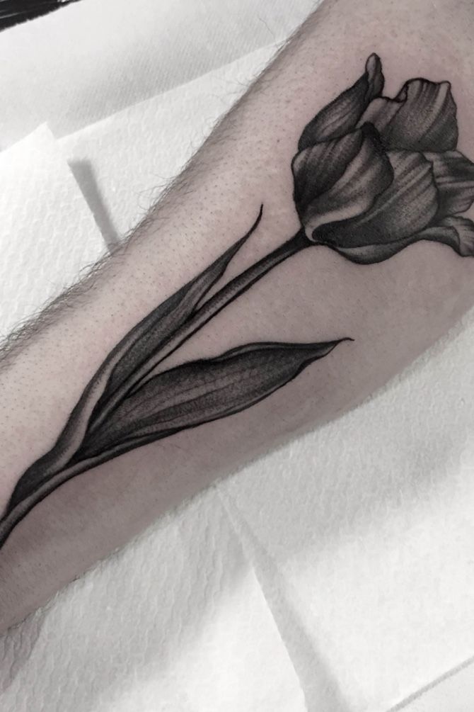 a black and white photo of a flower on the arm