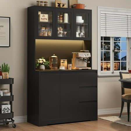 a black cabinet with glass doors in a dining room