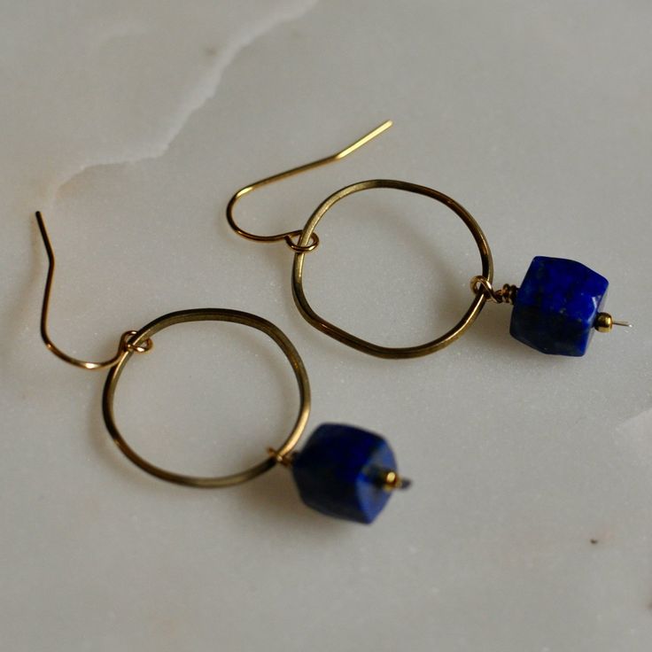 The Lapis Brass hoops feature a gorgeous, faceted lapis nugget bead on a wavy brass hoop that is secured to an elegant ear wire. The deep blue of the bead is reminiscent of the rich color of Lake McDonald. These hoop earrings are mindfully made with high-quality, gold-plated metals. They are nickel-free and safe for sensitive ears. If you have additional allergies that restrict which metals you can wear, please contact me first before purchasing. I do have sterling silver, gold-filled, or hypoal Lake Mcdonald, Brass Hoop Earrings, Brass Hoops, Jewelry Safe, Paper Tape, Handmade Gold, Sensitive Ears, Ear Wire, Deep Blue