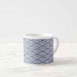 a blue and white cup sitting on top of a table