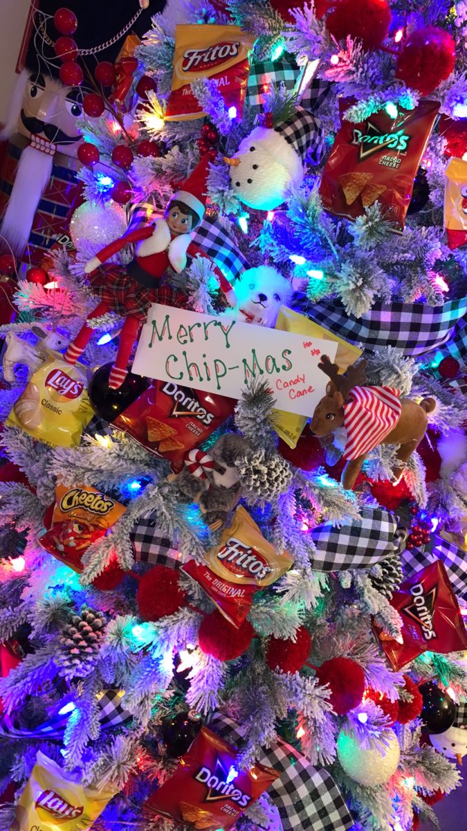 a christmas tree decorated with candy bars and ornaments