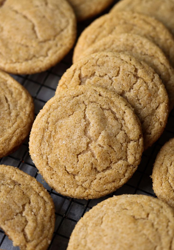 chewy apple cider cookies on a cooling rack with a sign in the background