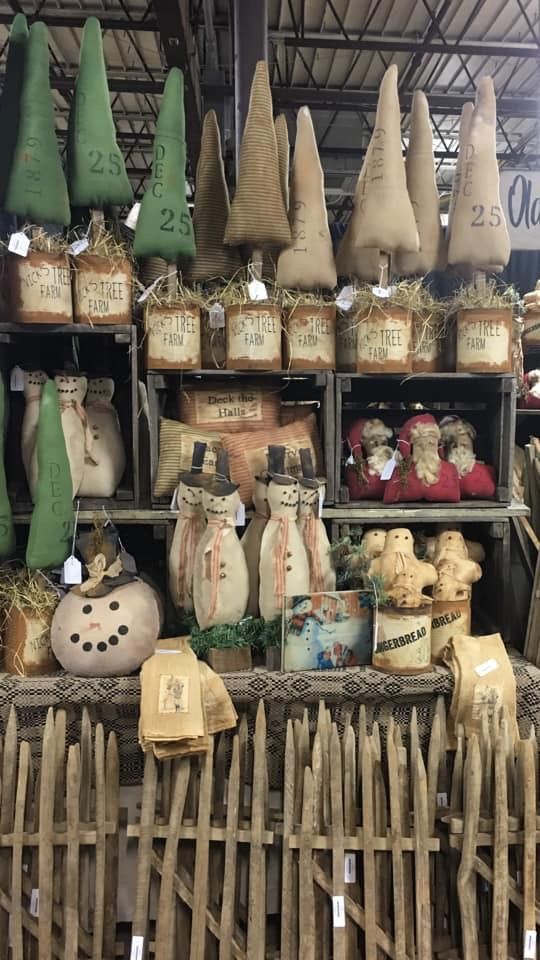 an outdoor market with many items for sale on the shelves and in front of them