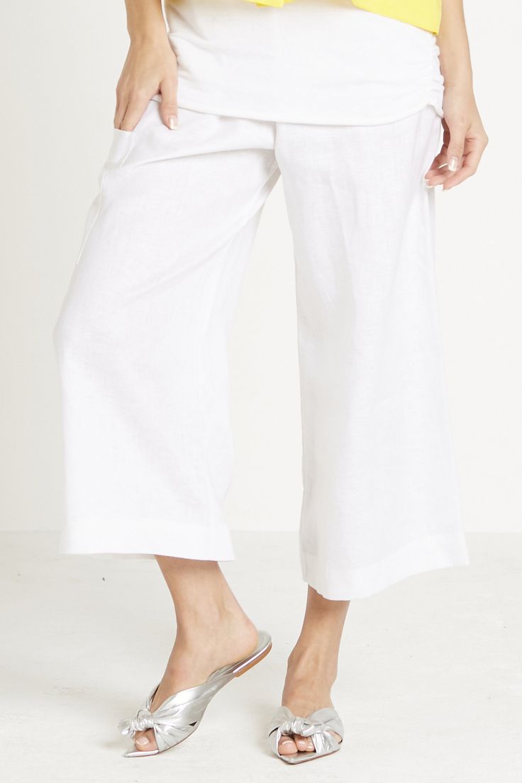 Linen Pant - pull on elastic waist, flood length pant. Lower right leg on the theigh there is a patched pocket for a cell phone,  wide leg. Relaxed Fit Pull-on Pants, Relaxed Fit Wide Leg Pants With Pull-on Style, Relaxed Fit Wide Leg Pull-on Bottoms, Chic Cropped Leg Pull-on Pants, Summer Bottoms With Elastic Side Panels And Loose Fit, Versatile Cropped Wide Leg Pants With Pockets, Versatile Wide Leg Cropped Pants With Pockets, White Wide-leg Bottoms With Patch Pockets, White Wide Leg Bottoms With Patch Pockets