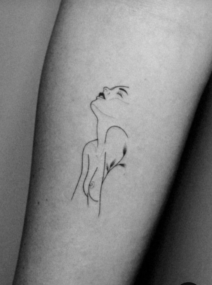 a woman's arm with a small tattoo on the left side of her leg