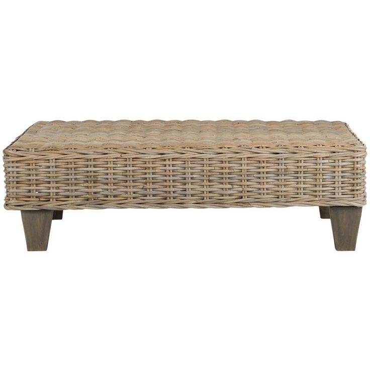 a wicker bench with wooden legs and an upholstered design on the top