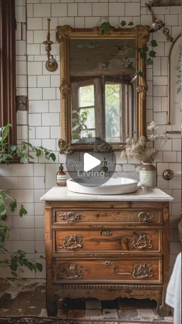 a bathroom with a sink, mirror and plants on the counter in front of it