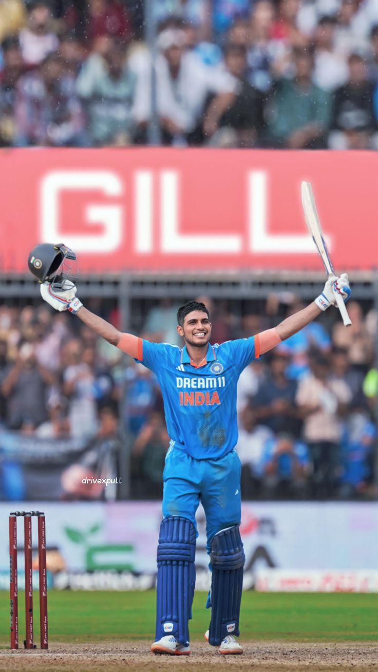 a cricket player holding his arms up in celebration