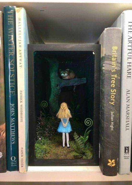 there is a book shelf with books on it and a doll in the doorway,