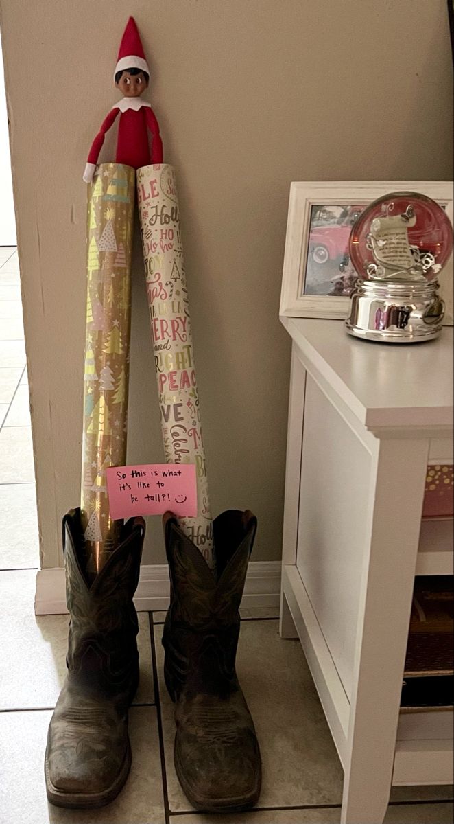 a pair of cowboy boots sitting on top of a counter next to a sign that says happy birthday