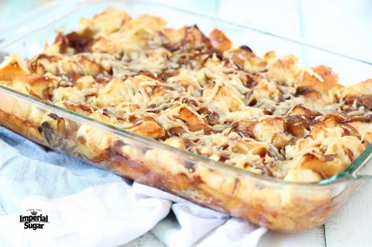 a casserole dish filled with bread and other toppings on a white table