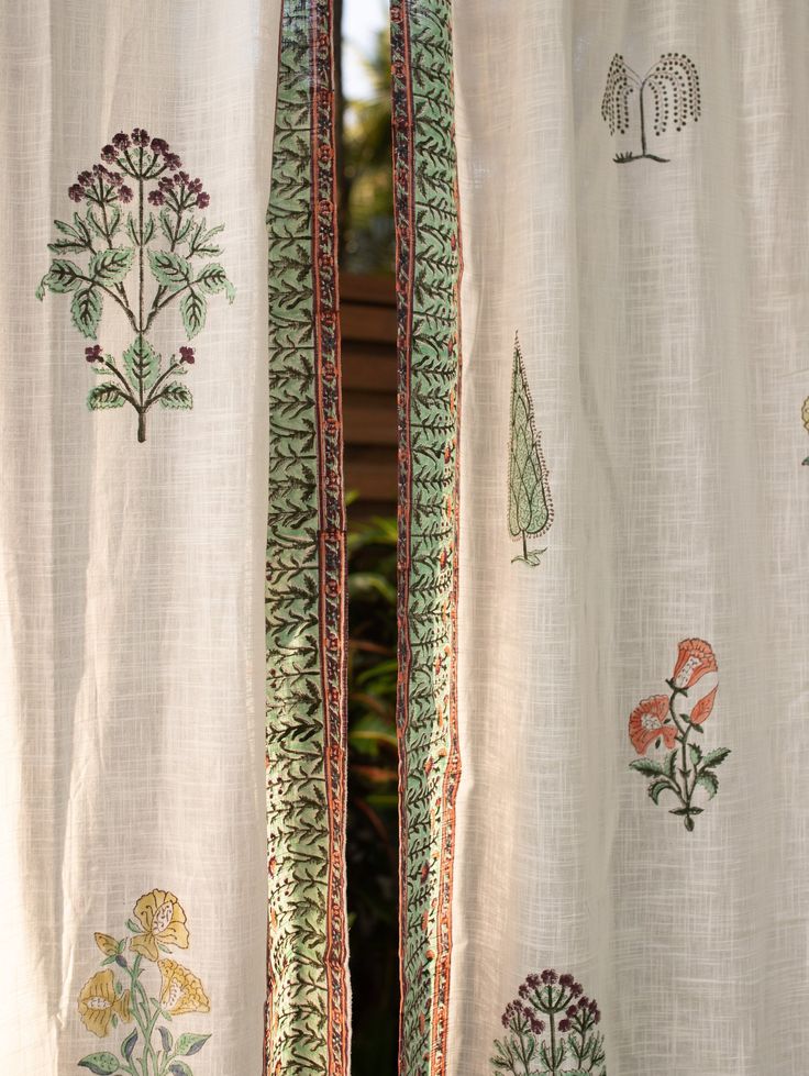 the curtains are decorated with flowers and trees