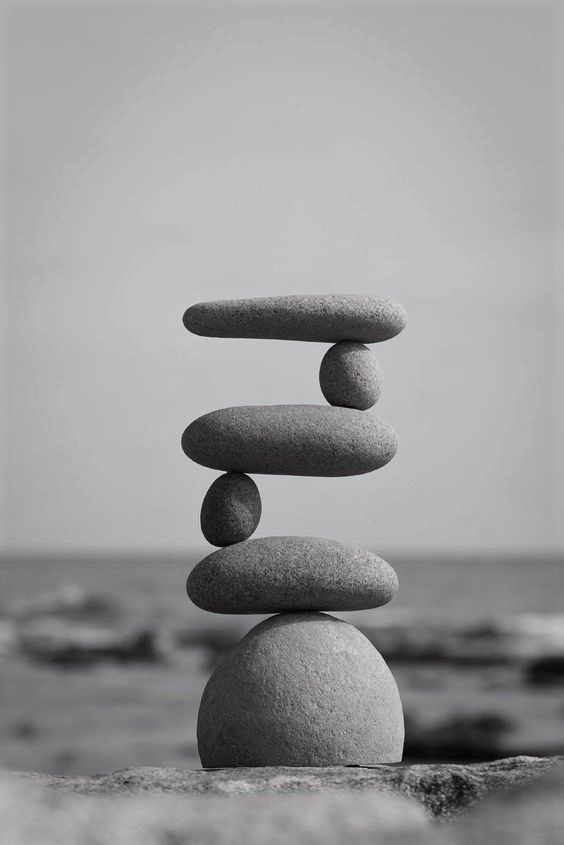 rocks stacked on top of each other in front of the ocean