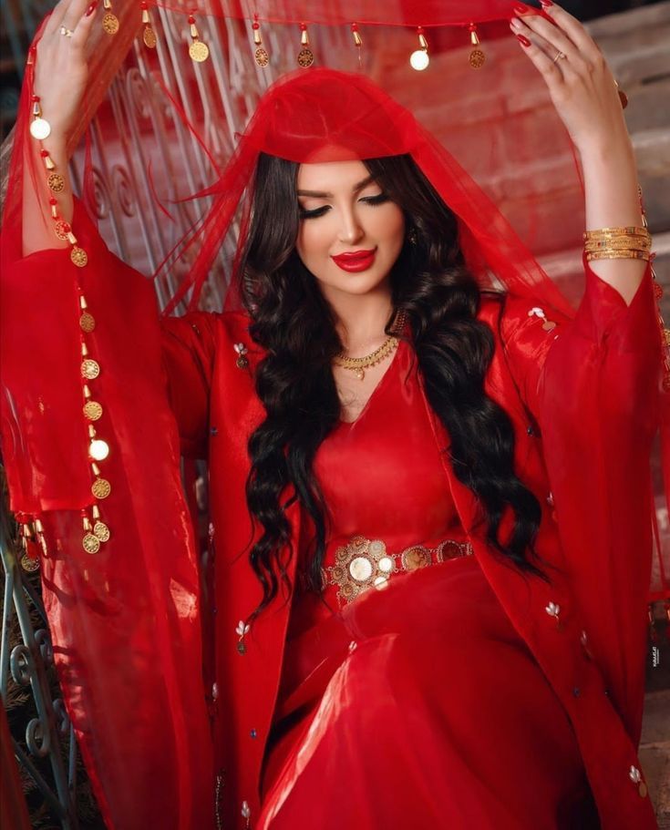 a woman dressed in red poses for the camera