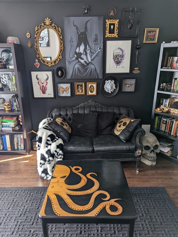 a living room filled with black furniture and pictures on the wall above it's coffee table