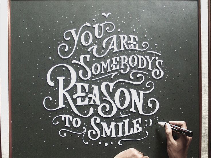 a person writing on a chalkboard that says you are somebody's reason to smile