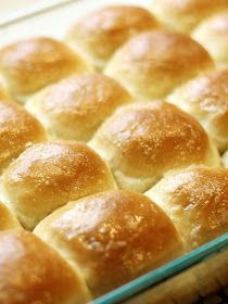 a baking pan filled with rolls on top of a table