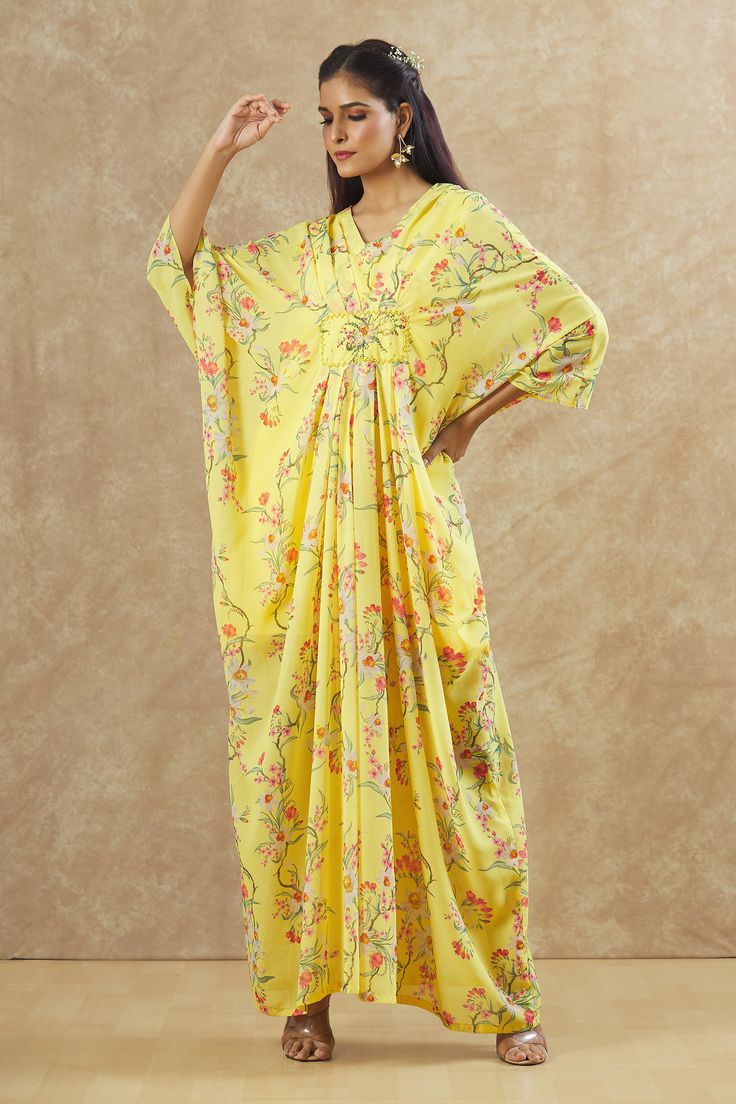 Yellow georgette kaftan with floral print and sequins and beaded hand embroidered placement patchwork. Comes with an inner.
Components: 2
Pattern: Printed, Hand embroidered
Type Of Work: Floral, Sequins, Beads
Neckline: V Neck
Sleeve Type: Kaftan : Flared Sleeves, Inner : Sleeveless
Fabric: Georgette
Color: Yellow
Other Details: 
Front pleats
Occasion: Sangeet - Aza Fashions Georgette Kaftan, V Neck Kaftan, Beaded Neckline, Fashion App, Flared Sleeves, Aza Fashion, Sleeve Type, Hand Embroidered, Types Of Sleeves