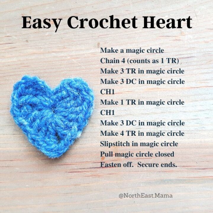 a crochet heart on a wooden table with instructions for how to make it