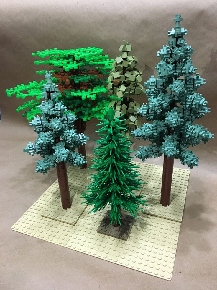 three trees made out of legos are shown on the twitter account, and one is green