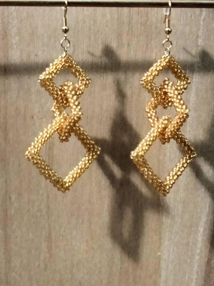 These three inch earrings are comprised of hand stitched gold beaded squares. They have gold tone ear wires. Gold Beaded Drop Earrings With Beaded Chain, Gold Beaded Chain Drop Earrings, Gold Beaded Chain Earrings As Gift, Gold Beaded Earrings With Ear Wire For Party, Gold Beaded Earrings With Beaded Chain For Party, Handmade Gold Beaded Earrings For Party, Gold Beaded Chain Earrings For Party, Handmade Elegant Rectangular Beaded Earrings, Rectangular Gold Beaded Jewelry