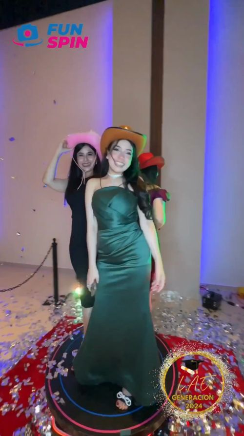 two women standing next to each other in front of a red and blue carpet with confetti on it