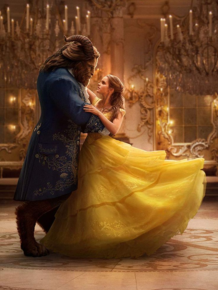 the beauty and the beast character hugging each other in front of a chandelier