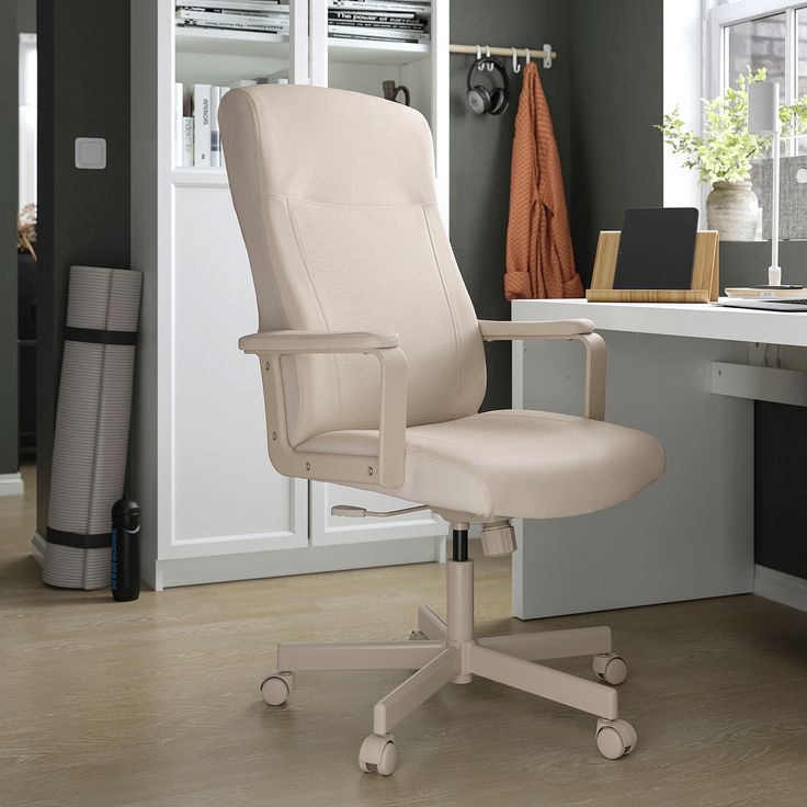 a white office chair sitting on top of a hard wood floor next to a desk