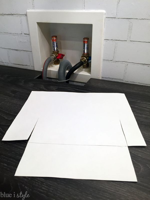 two white pieces of paper sitting on top of a table next to an electrical outlet