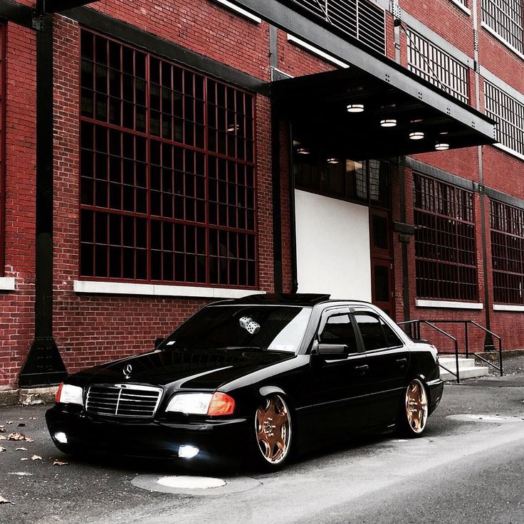 a black car parked in front of a building