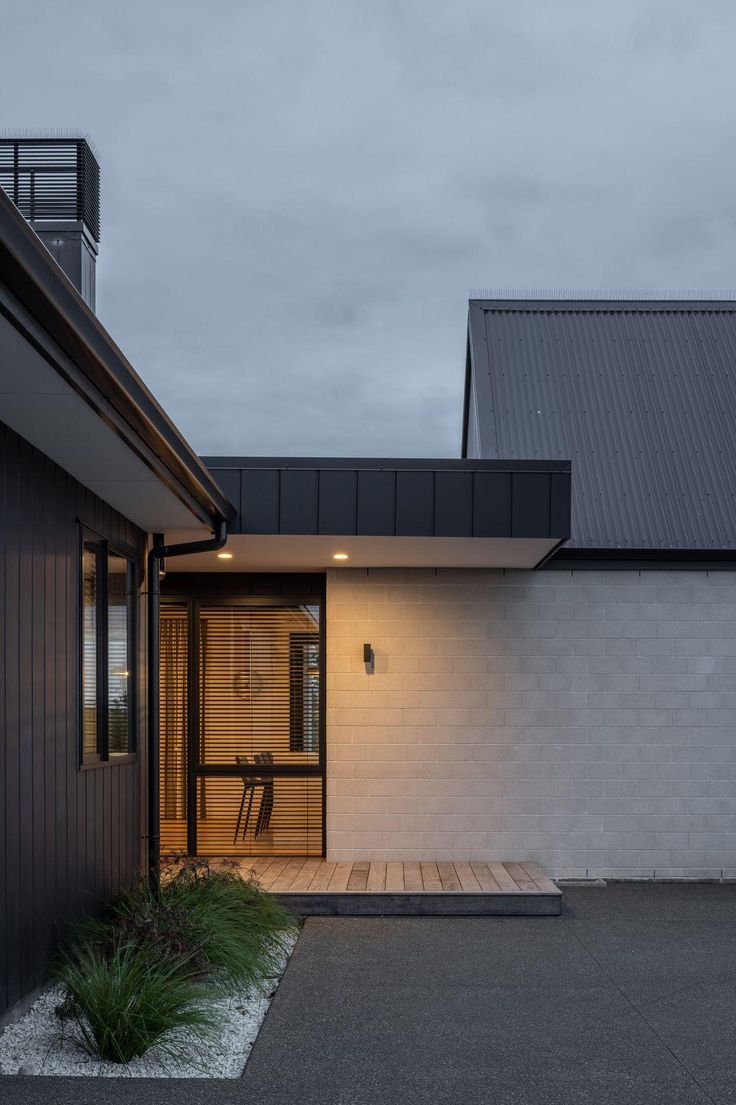 a house with a wooden walkway leading to the front door