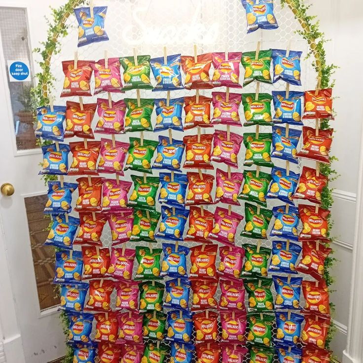 a bunch of candy bars are stacked up on a wall in front of a door