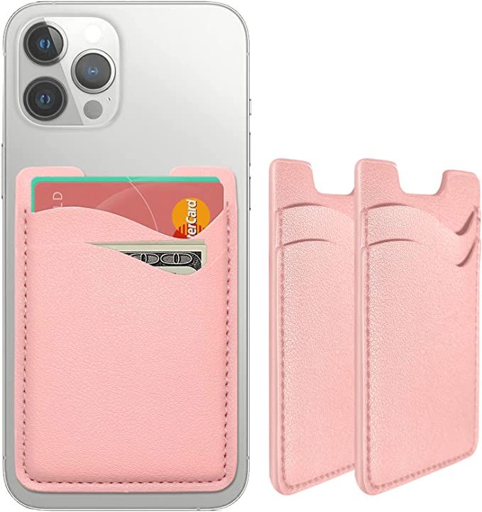 two pink wallets are next to an iphone case with money sticking out of it