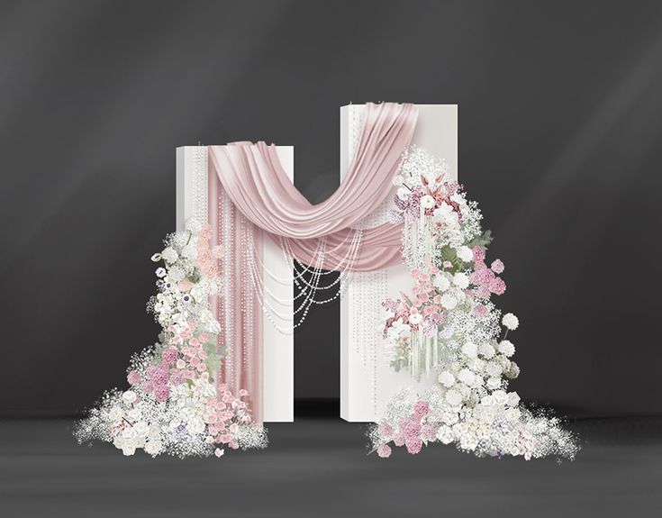 an image of a wedding arch with flowers and pearls on the front, set against a black background