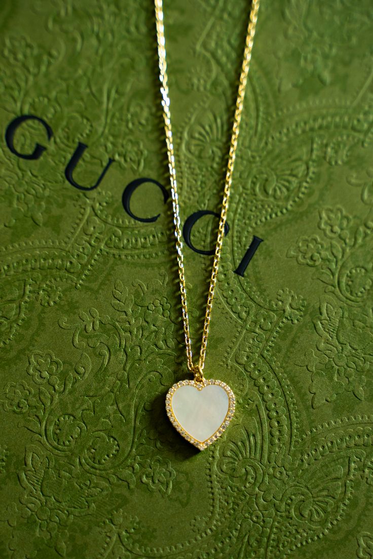 Shimmering mother-of-pearl inlay exudes a tranquil style straight from the sea, making our Everly Necklace perfect for wearing or gifting as a keepsake. Sparkling round brilliant cut cubic zirconia around the mother of pearl add elegance, all set on a delicate cable chain. Created in gold plated stainless steel, this heart pendant is perfect for wearing any time for a pick-me-up. Metal Type: 925 Sterling SilverMetal Plating: Gold PlatedStone: ZirconLength: 16" to 18" Luxury Diamond White Necklace As A Gift, White Diamond Necklace As A Gift For Her, Mother Of Pearl Necklace For Anniversary, White Gold Gemstone Jewelry With Mother Of Pearl, White Gold Mother Of Pearl Necklace For Anniversary, Anniversary Pearl Pendant Necklace In Mother Of Pearl, Anniversary White Gold Necklaces With Mother Of Pearl, Anniversary White Gold Mother Of Pearl Necklaces, Anniversary White Gold Necklace With Mother Of Pearl