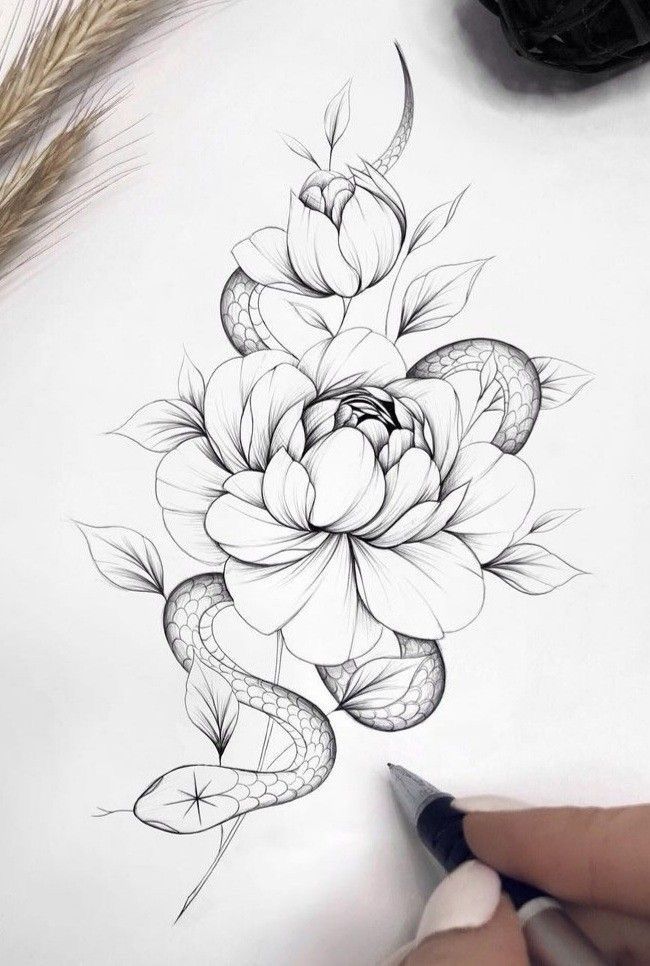 a drawing of a flower and snake on paper