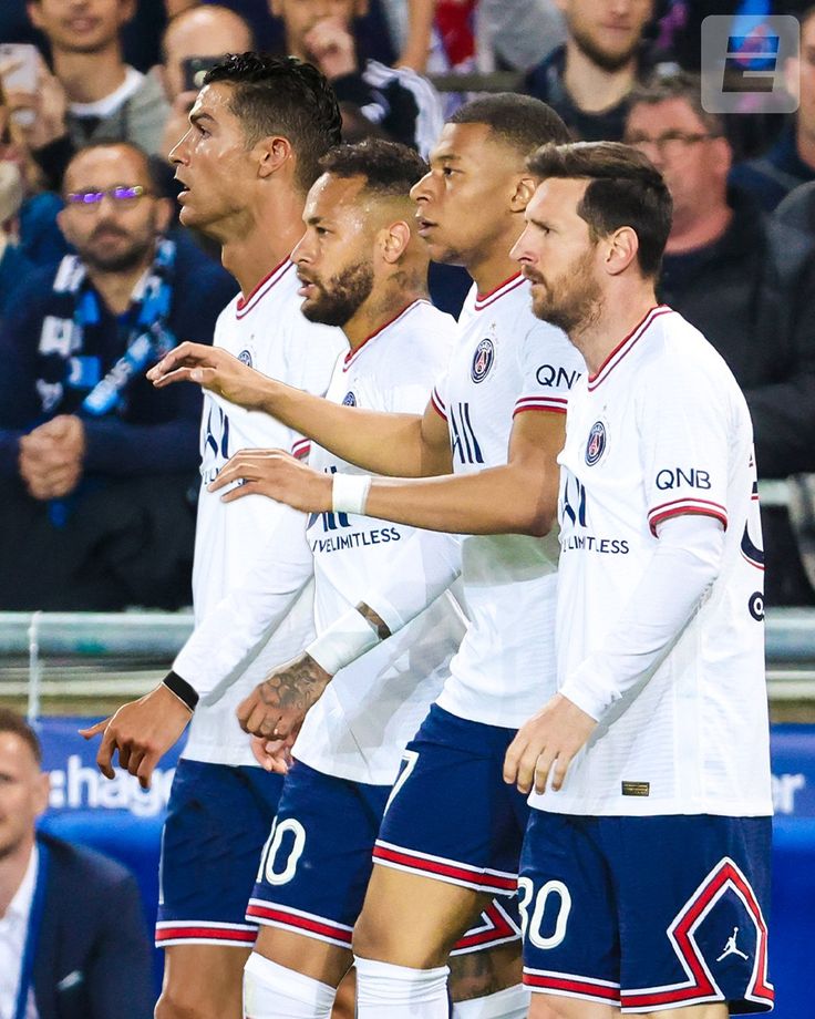 several soccer players are standing together in front of an audience