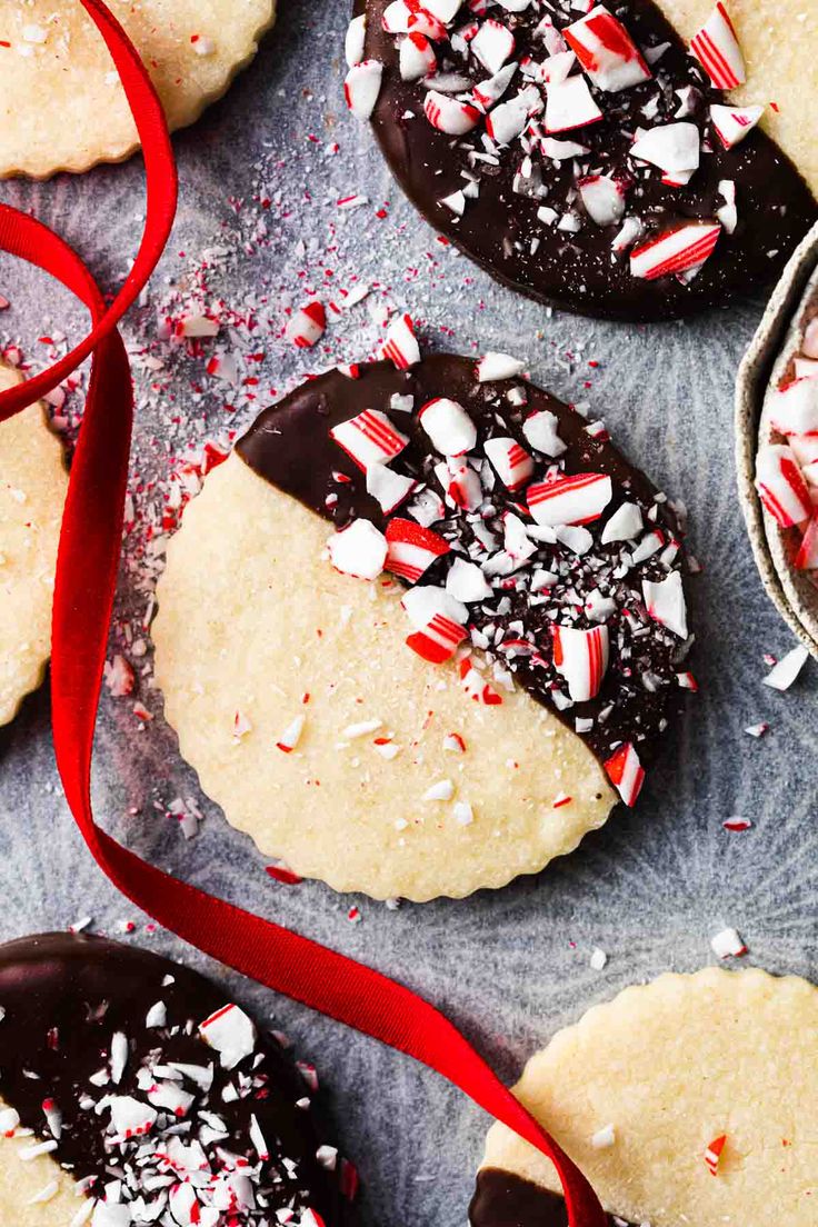 cookies decorated with chocolate and candy canes on a table