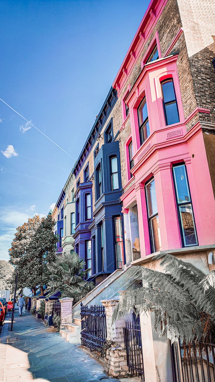 a row of multi - colored buildings on a city street