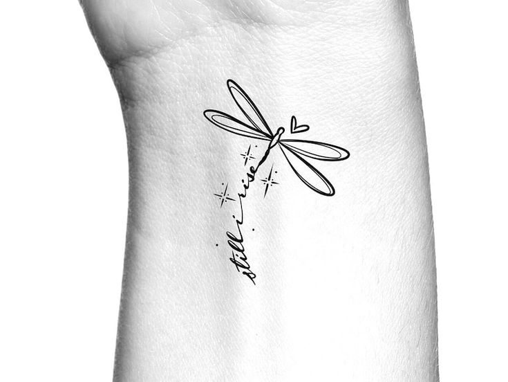 a black and white photo of a dragonfly tattoo