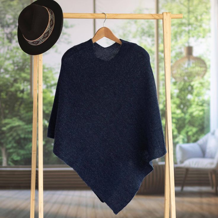 A classic and beautiful design, this elegant poncho is presented by artisan Alfredo Falcon of Peru. Indigo in color, the soft and warm garment is knit from 100% alpaca wool. Winter Alpaca Cape Poncho, Winter Alpaca Poncho Cape, Cozy Wool Poncho Cape, One Size Alpaca Poncho For Fall, Oversized Alpaca Poncho For Winter, Cozy Cashmere Poncho For Winter, Cozy Cashmere Winter Poncho, Wool Poncho Cape One Size, Wool Cape Poncho One Size