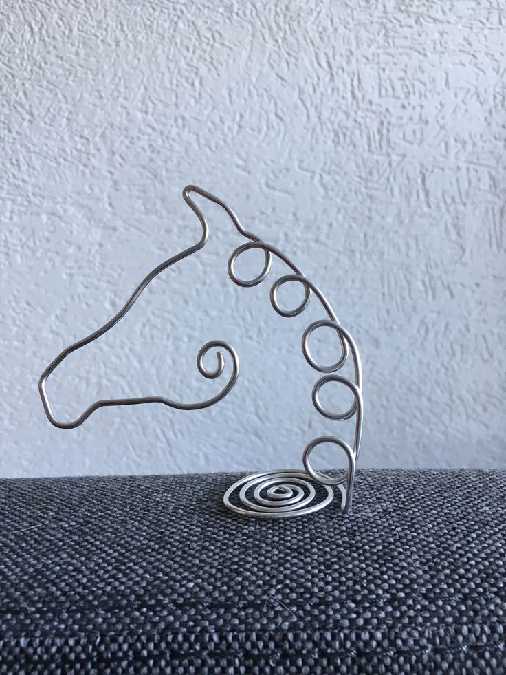 a metal horse head sitting on top of a table