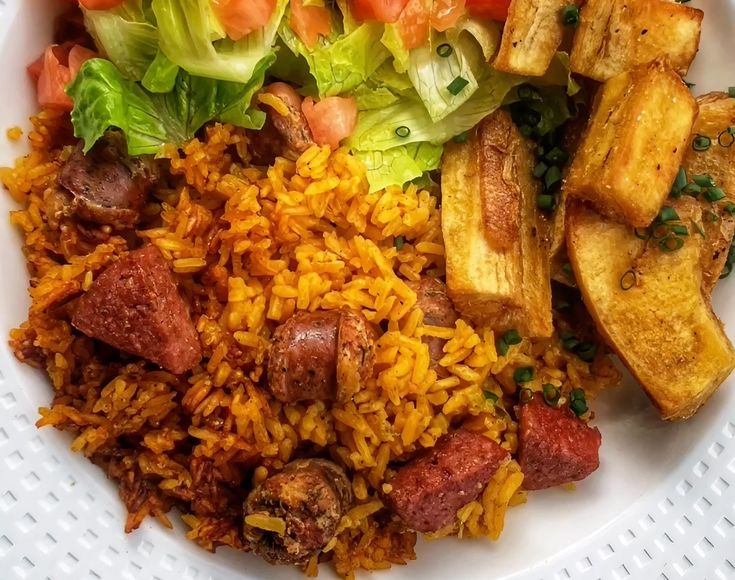 a white plate topped with rice, meat and veggies on top of it