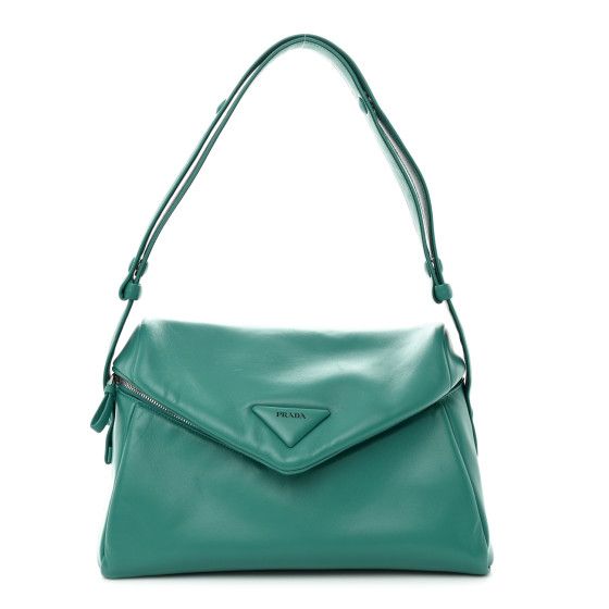 This is an authenticPRADA Nappa Padded Signaux Bag in Turquoise. This distinctive satchel is crafted of smooth, soft Nappa leather in light blue. The bag features an adjustable leather shoulder strap and double zippers on the V shaped flap. The top opens to a matching Prada monogram jacquard weave fabric interior with a zipper pocket. Designer Green Flap Bag For Travel, Luxury Green Shoulder Bag With Dust Bag, Luxury Turquoise Travel Bags, Green Leather Bag With Magnetic Closure, Designer Green Satchel Shoulder Bag, Green Top Handle Shoulder Bag With Magnetic Closure, Green Shoulder Satchel With Magnetic Closure, Green Satchel Flap Bag With Magnetic Closure, Luxury Green Tote Flap Bag