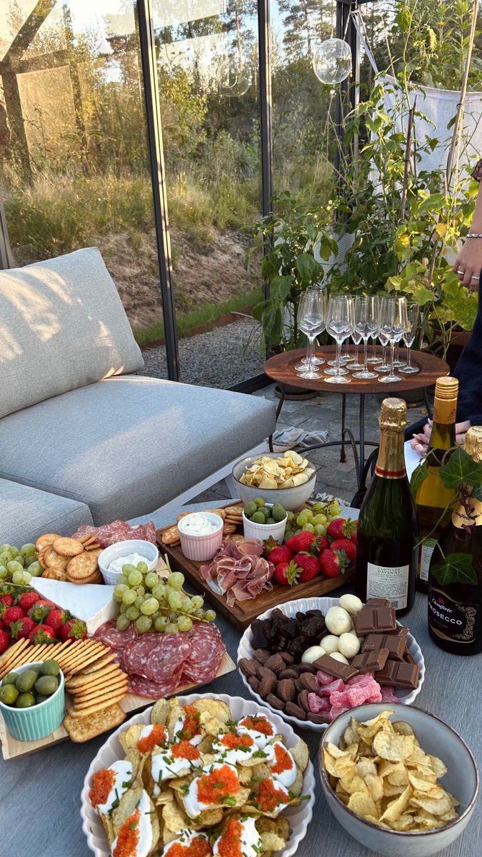 a table filled with different types of food and wine