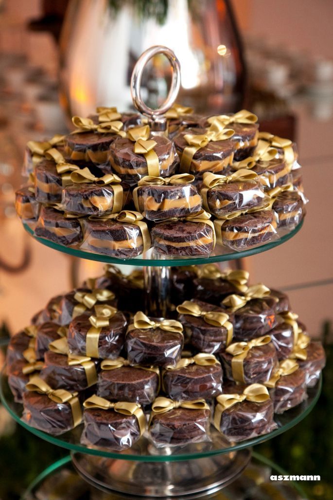 three tiered trays filled with chocolate covered donuts