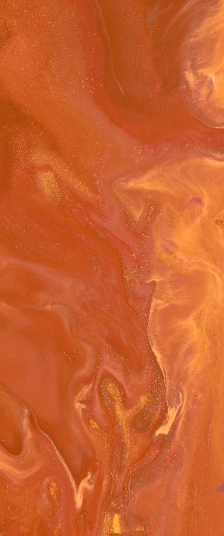 an orange and red liquid swirls in the air