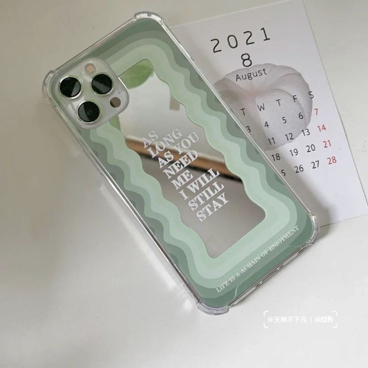 a phone case sitting on top of a table next to a calendar