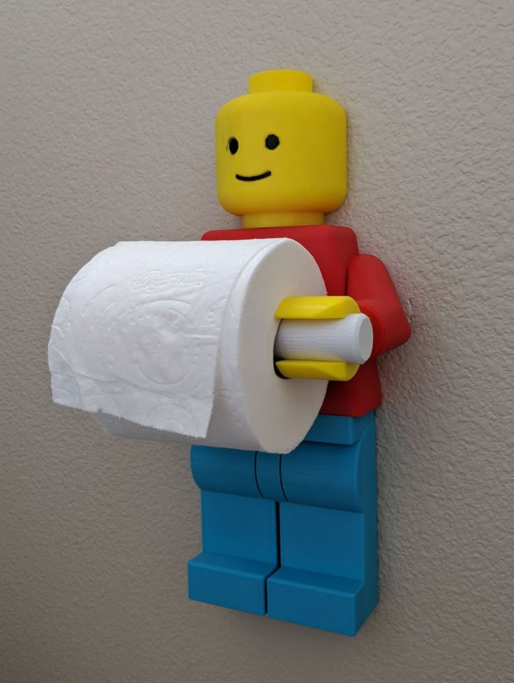 a lego man holding a roll of toilet paper