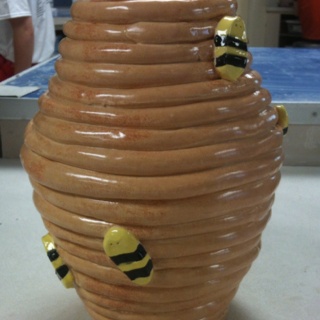 a vase that has some bees on it